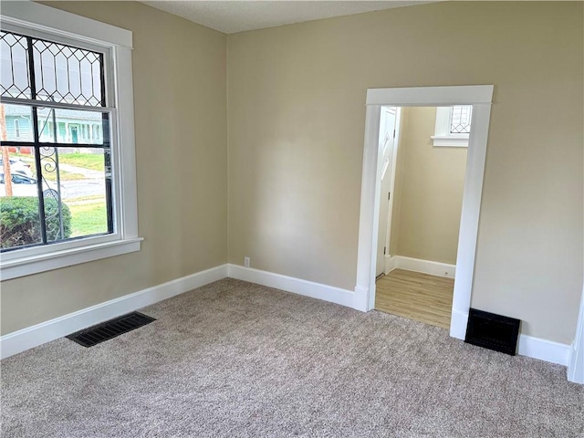 spare room with light carpet