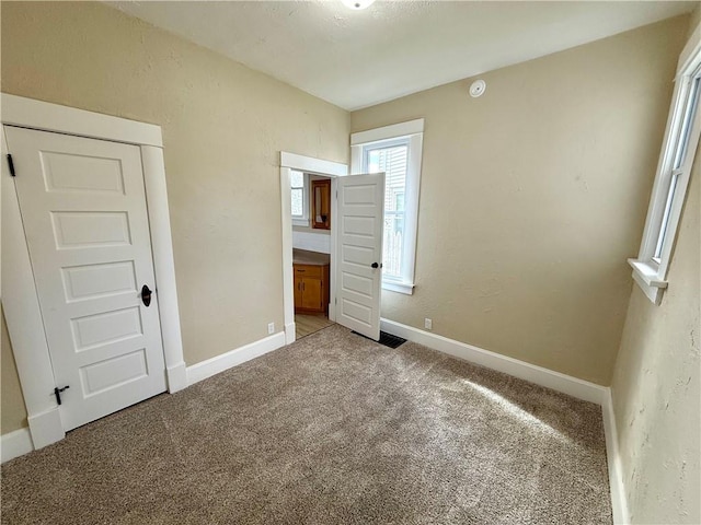 unfurnished bedroom with carpet floors and a closet