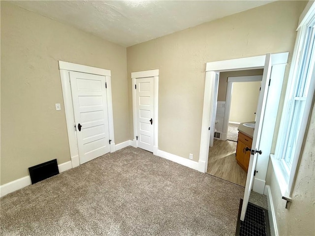 unfurnished bedroom with carpet floors and a closet