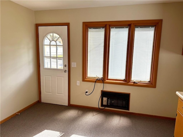 doorway to outside featuring carpet flooring and heating unit