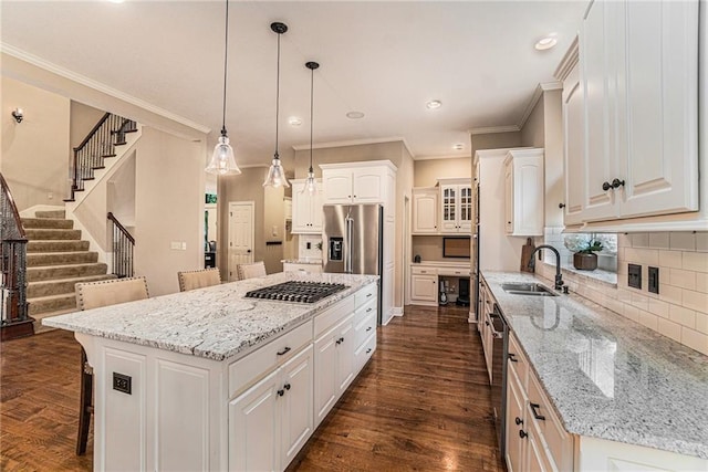 kitchen with sink, a center island, white cabinets, and dark hardwood / wood-style flooring