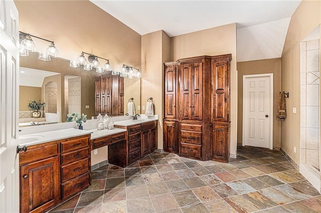 bathroom featuring vanity and vaulted ceiling