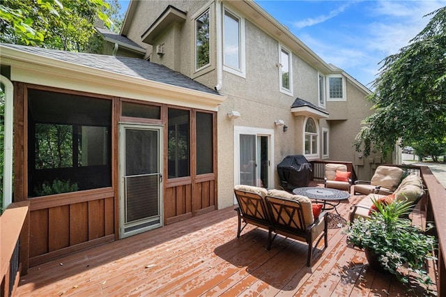 deck featuring a fire pit and a grill