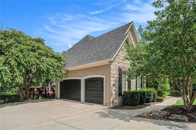 view of side of home featuring a garage