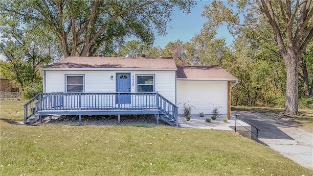 view of front of home with a front yard and a wooden deck