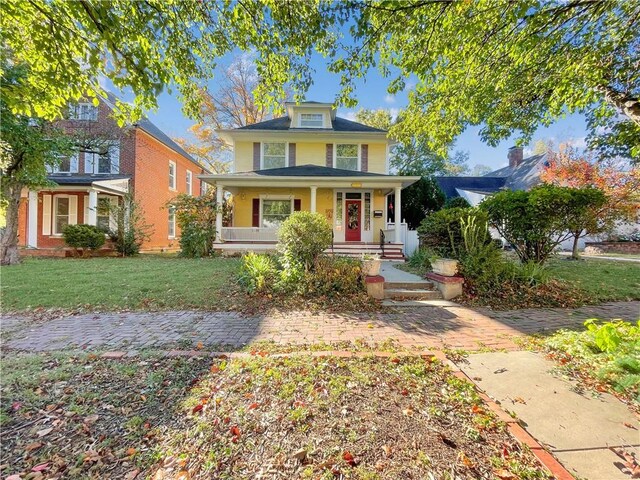 view of front of home featuring a front lawn and covered porch