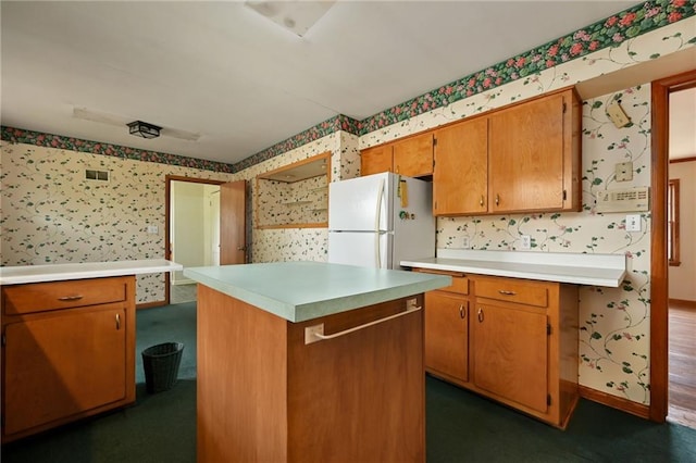 kitchen featuring a center island and white fridge