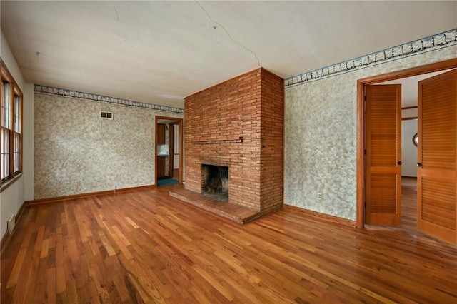 unfurnished living room featuring hardwood / wood-style floors and a fireplace