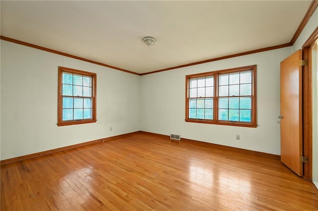 unfurnished room featuring crown molding and light hardwood / wood-style flooring