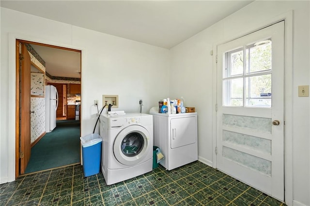 clothes washing area featuring separate washer and dryer