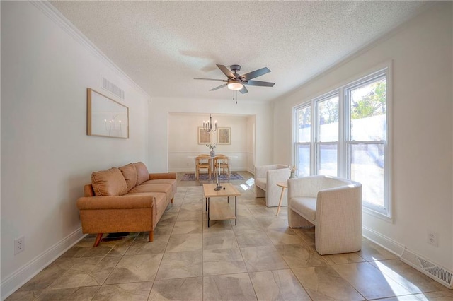 sitting room featuring ceiling fan with notable chandelier, a textured ceiling, and crown molding