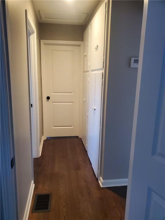 hallway with dark hardwood / wood-style flooring