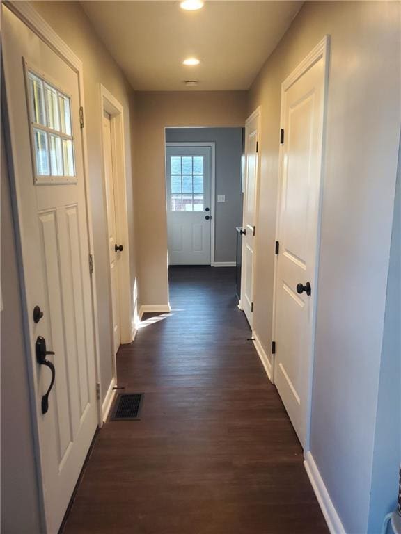 hallway with dark hardwood / wood-style floors