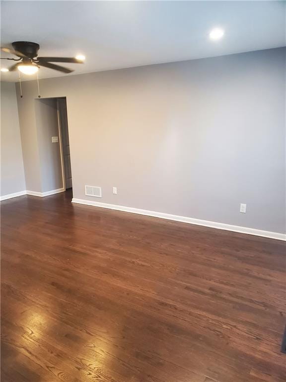 empty room featuring ceiling fan and dark hardwood / wood-style floors