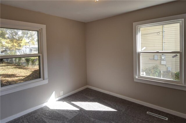820 W Oak St, Chanute, KS 66720 - unfurnished room with healthy amount of natural light, baseboards, and carpet flooring