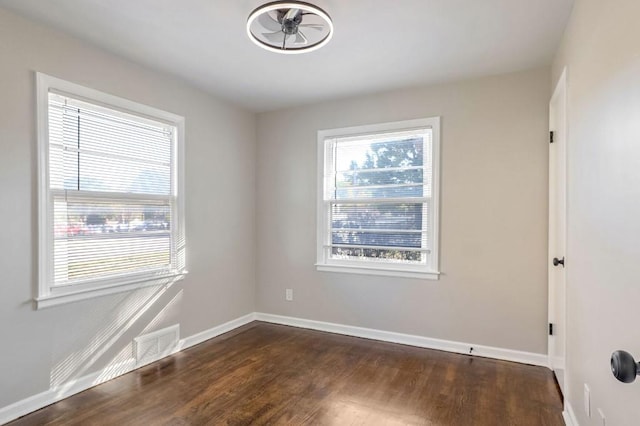 unfurnished room featuring ceiling fan and dark hardwood / wood-style floors