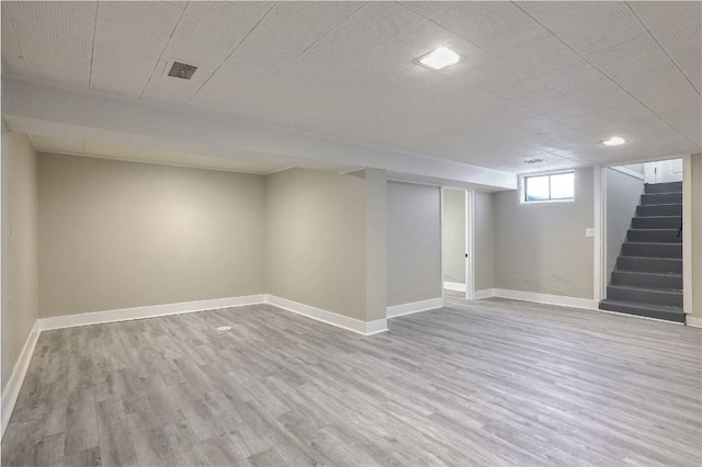 basement featuring light hardwood / wood-style flooring