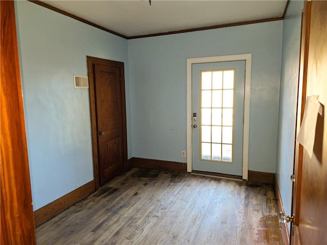 doorway to outside with hardwood / wood-style floors and ornamental molding