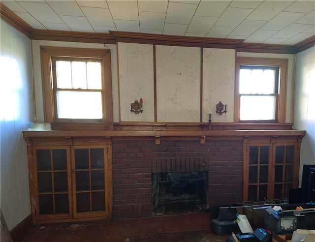 unfurnished living room featuring a wealth of natural light and a brick fireplace