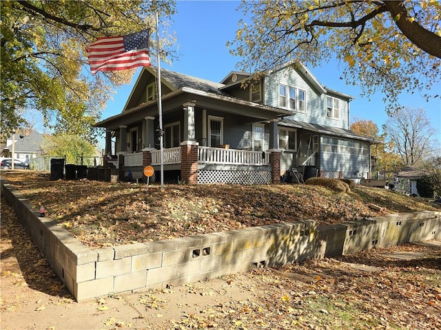 view of property exterior featuring covered porch