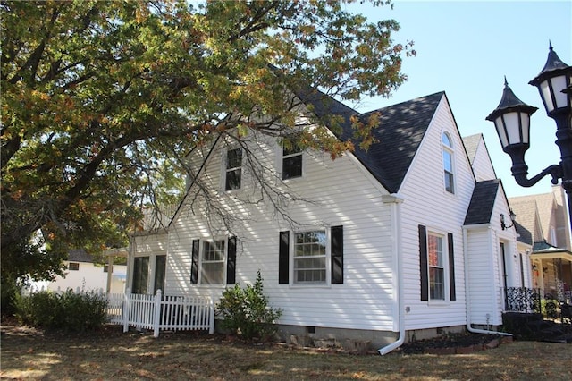 1201 W 4th St, Coffeyville, KS 67337 - view of front of house featuring a shingled roof and crawl space