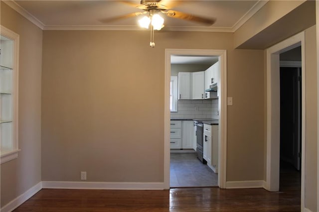 spare room featuring crown molding, dark hardwood / wood-style floors, and ceiling fan