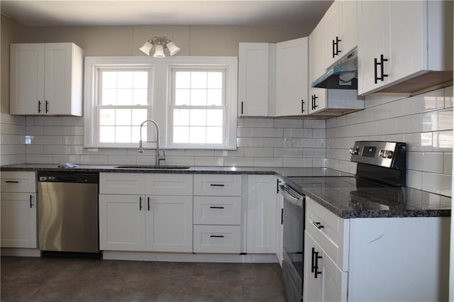 kitchen with tasteful backsplash, sink, stainless steel appliances, dark stone counters, and white cabinets