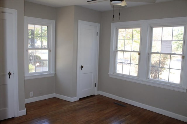 unfurnished bedroom with dark hardwood / wood-style floors and ceiling fan