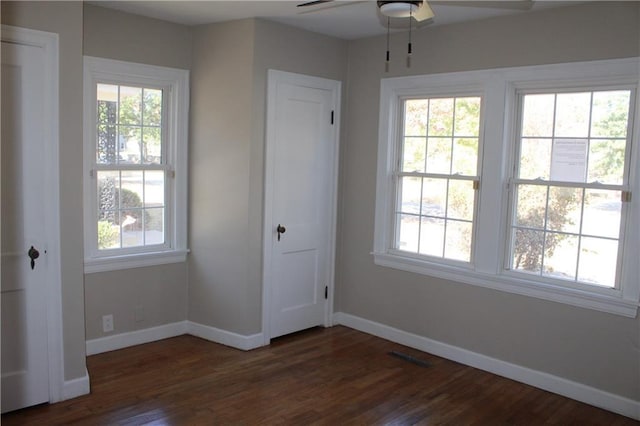 1201 W 4th St, Coffeyville, KS 67337 - unfurnished bedroom featuring baseboards and wood finished floors