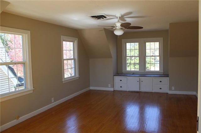 bonus room featuring lofted ceiling, a healthy amount of sunlight, and dark hardwood / wood-style flooring