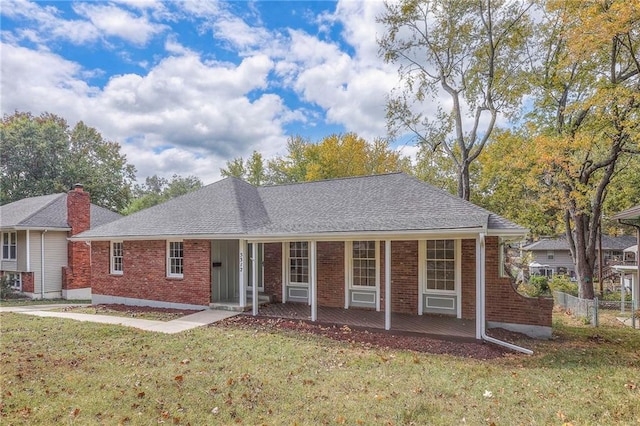 single story home with covered porch and a front lawn