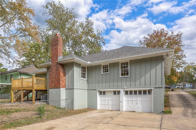 exterior space with a wooden deck and a garage