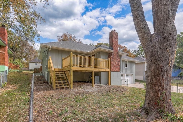 back of house featuring a yard and a deck