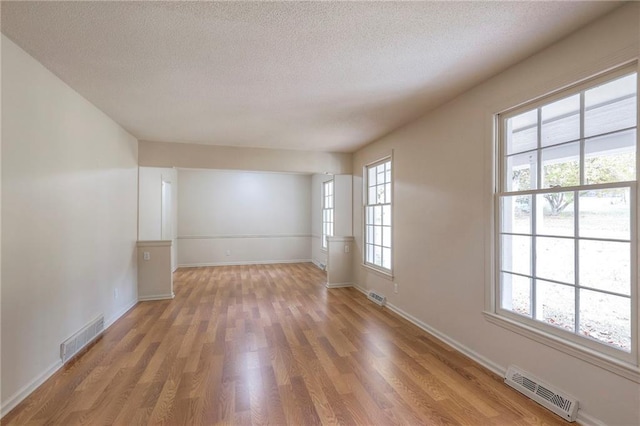 empty room featuring hardwood / wood-style floors and a textured ceiling