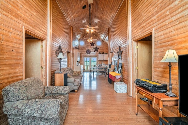 living room featuring ceiling fan, high vaulted ceiling, wood ceiling, and light wood-type flooring