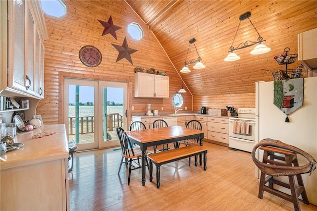 dining space with wood ceiling, high vaulted ceiling, light hardwood / wood-style floors, french doors, and wooden walls