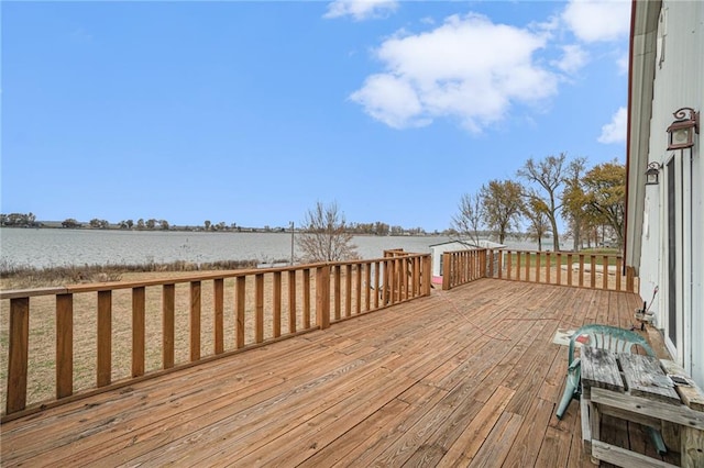 wooden deck featuring a water view