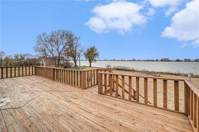 wooden terrace featuring a water view