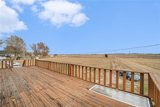 wooden deck featuring a rural view