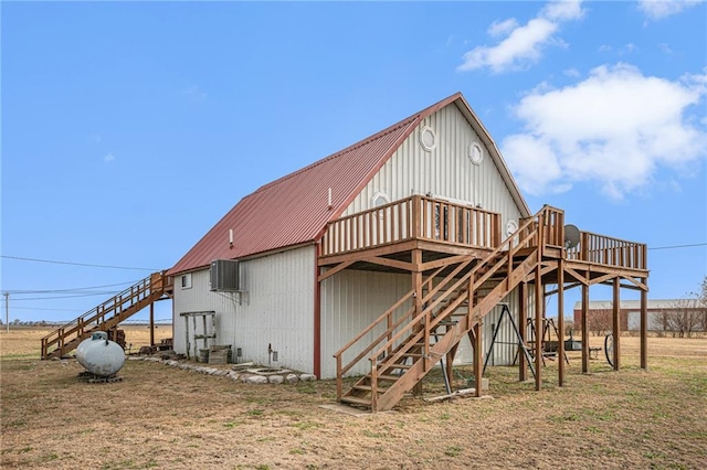 back of house featuring central air condition unit and a wooden deck