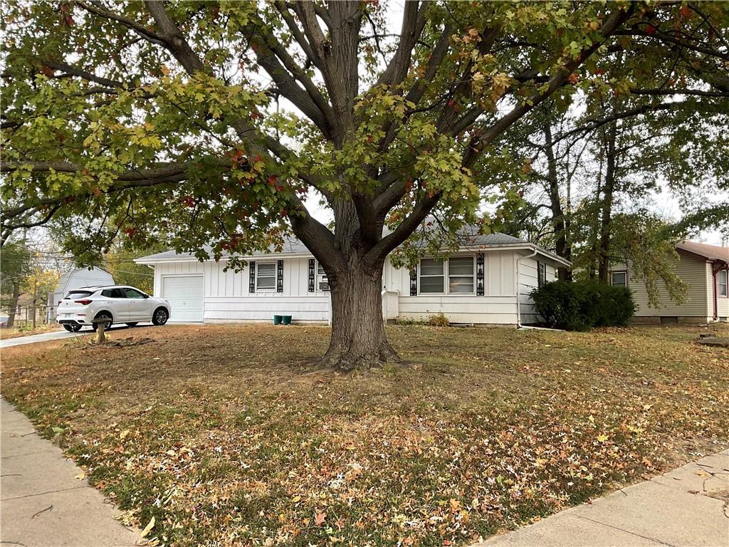 ranch-style home with a garage and a front yard