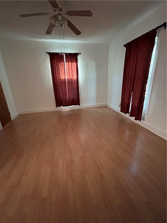 spare room with wood-type flooring and ceiling fan