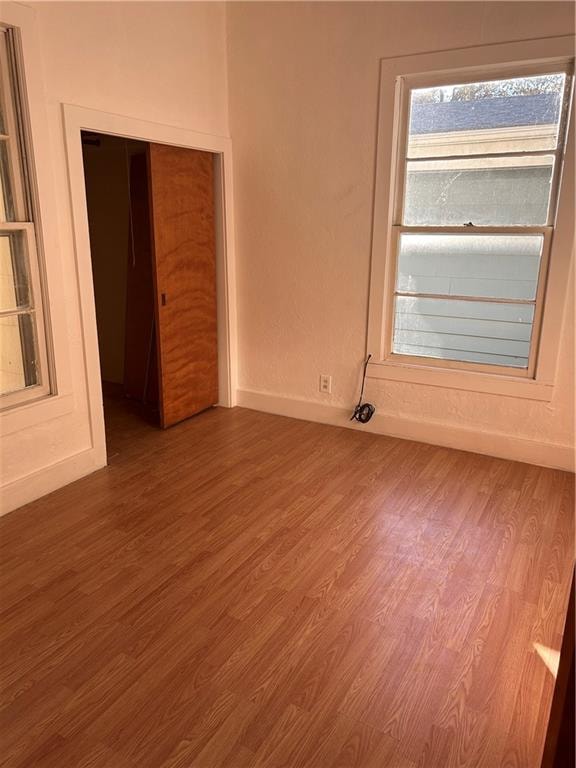 unfurnished room featuring hardwood / wood-style flooring