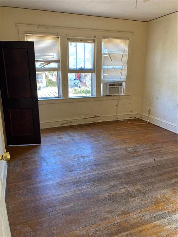 spare room with cooling unit and dark hardwood / wood-style floors