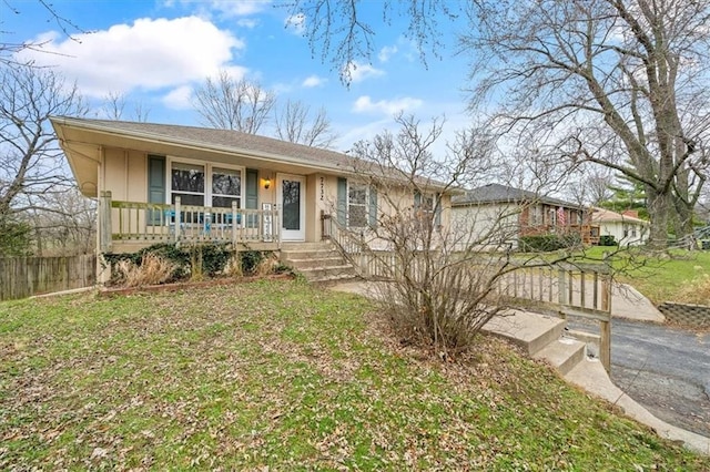 ranch-style house featuring a porch and a front yard