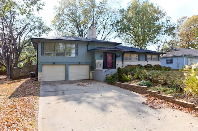 split level home featuring a garage and central AC unit