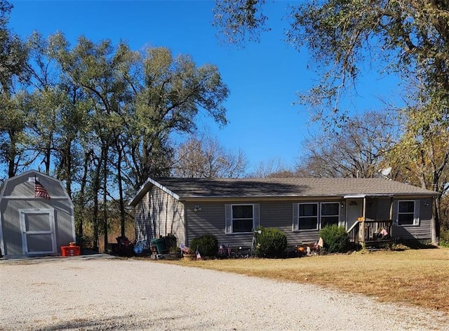 view of front of home with a front lawn and an outdoor structure