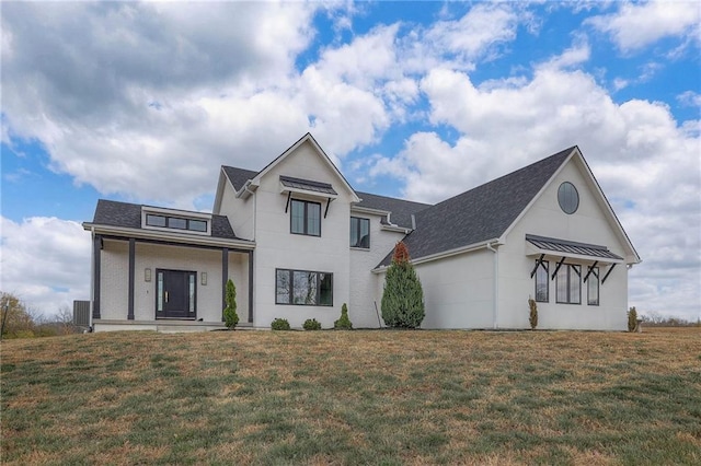 modern farmhouse with a porch and a front lawn