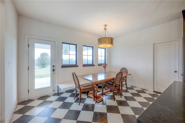 dining space with dark floors and baseboards