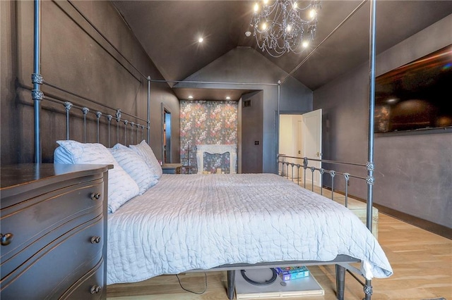 bedroom with lofted ceiling, a chandelier, and wood finished floors